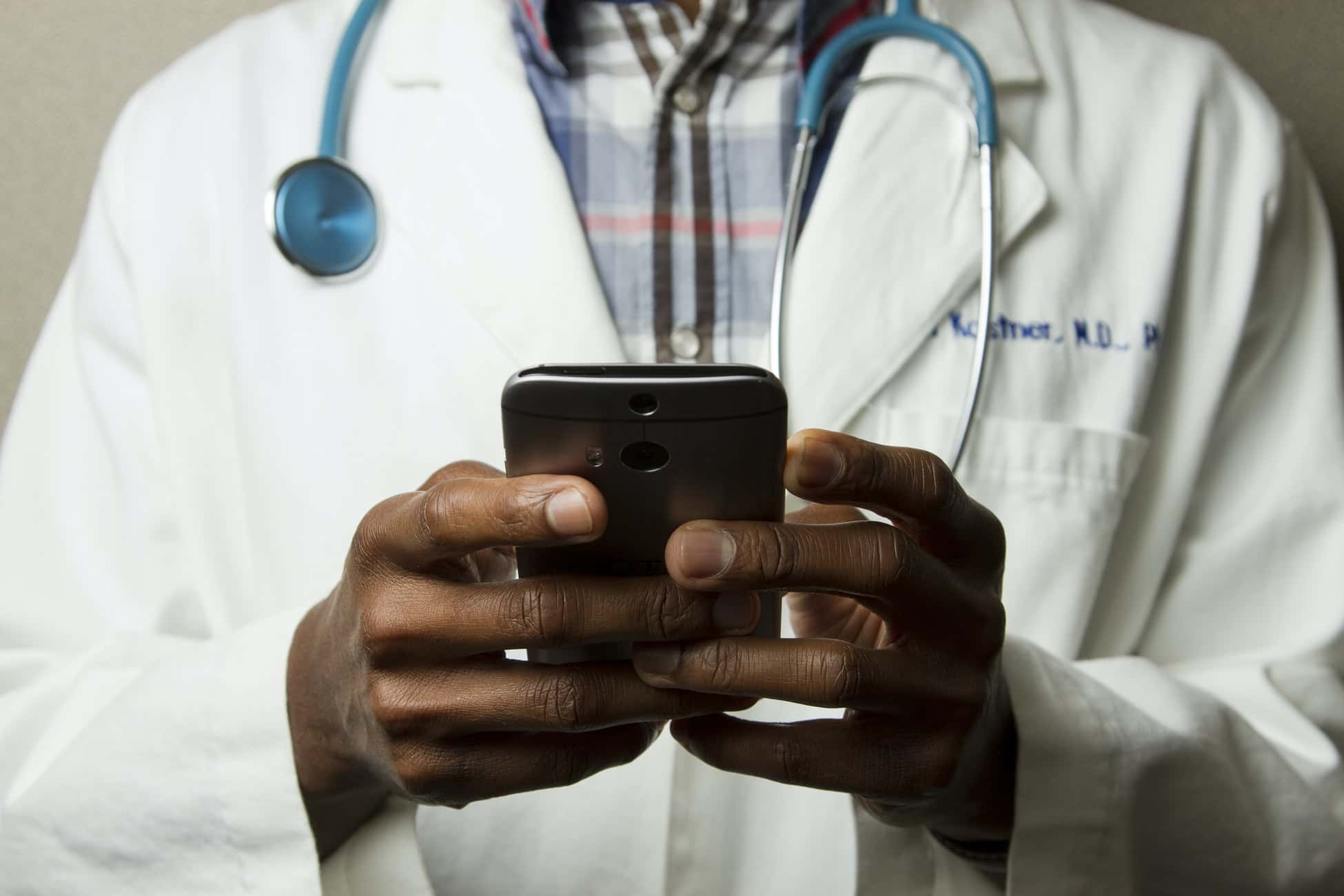 doctor is using his smartphone to manage patient consents and electronically sign documents
